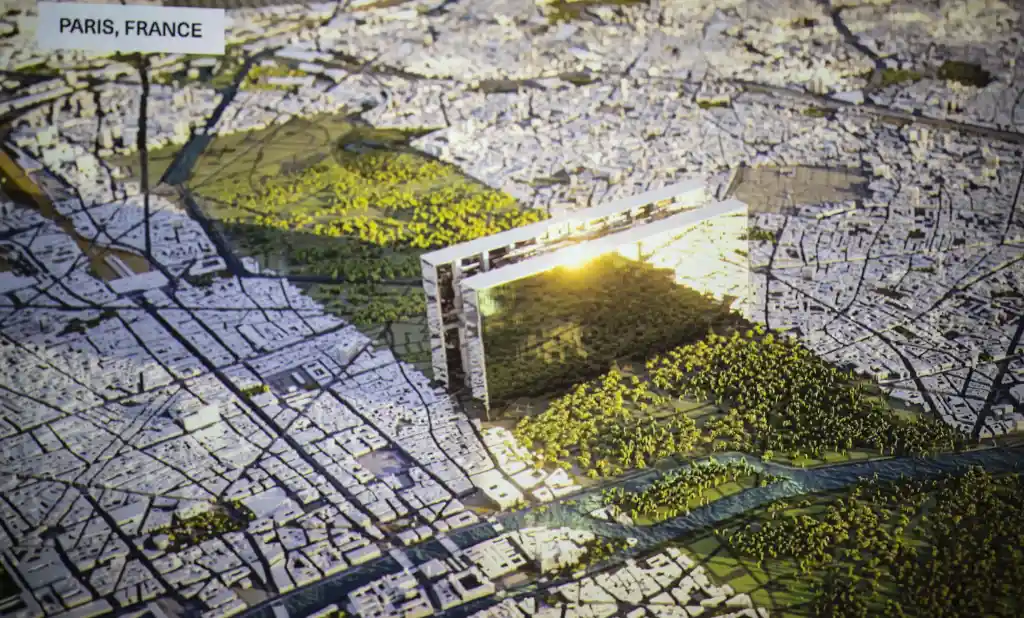 Illustration of a futuristic mirrored building called "The LINE" in a miniature city resembling Paris.