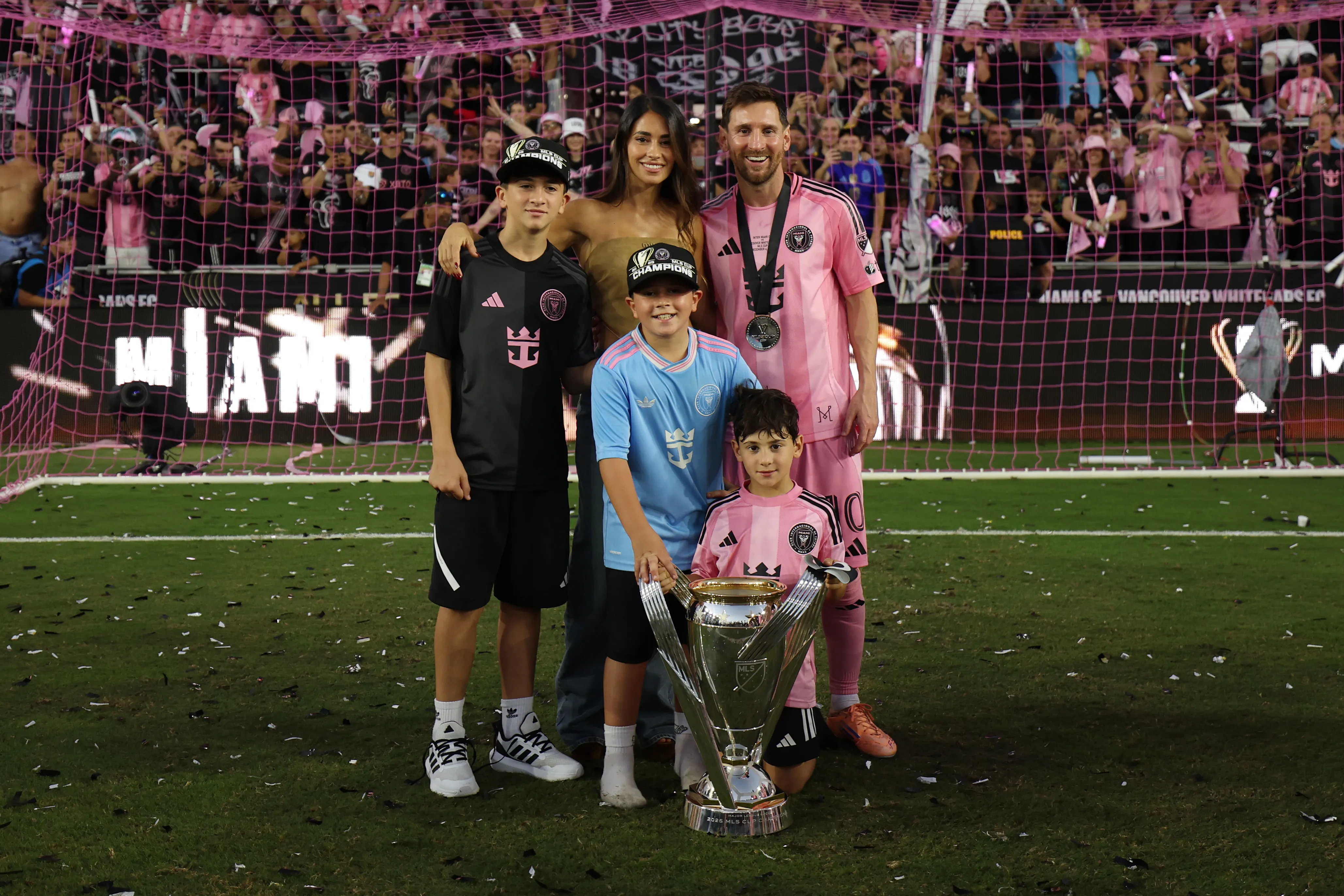 Lionel Messi and his family, with sons Thiago, Mateo, and Ciro, pose with the 2025 MLS Cup trophy.