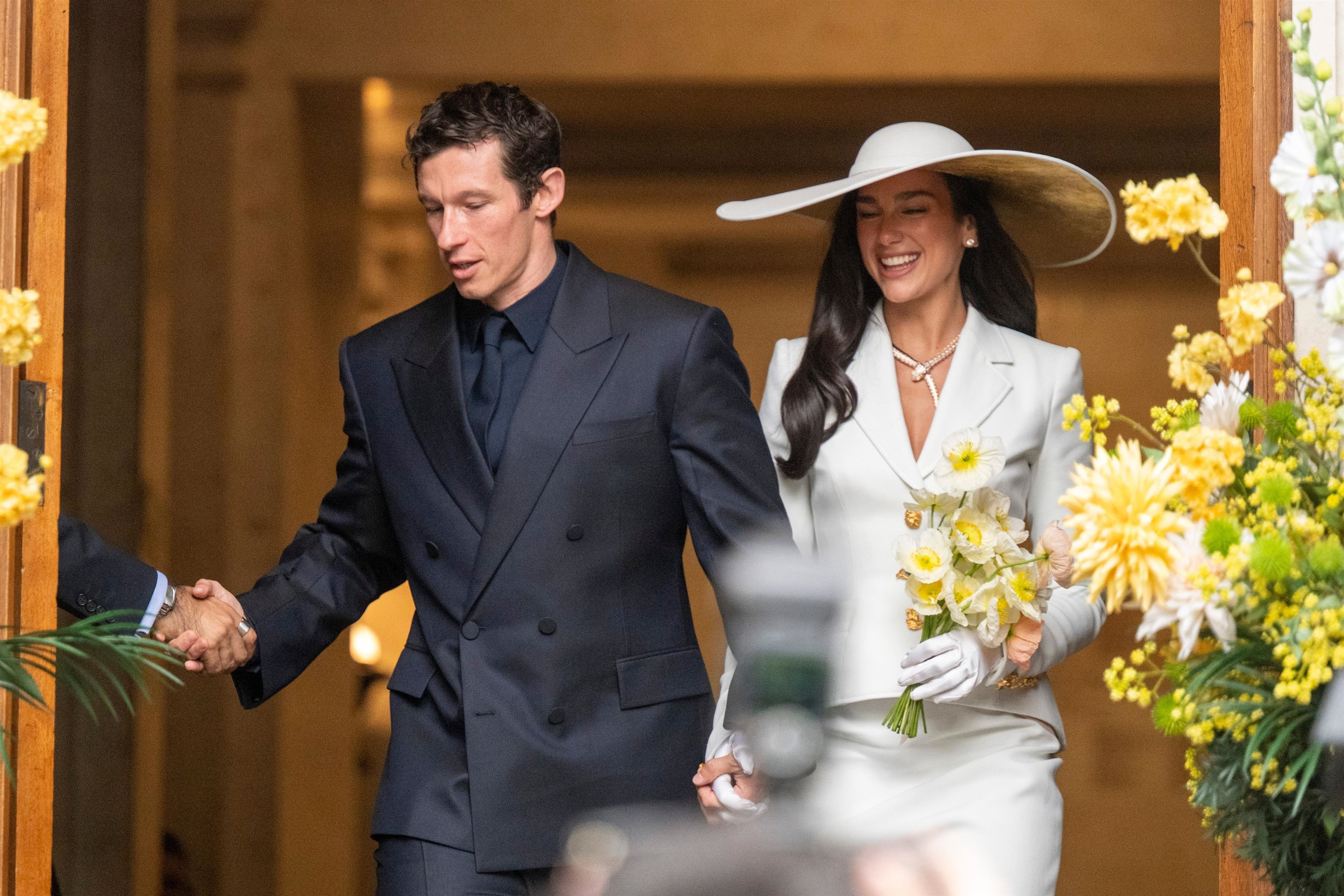 Callum Turner and Dua Lipa during their wedding in London