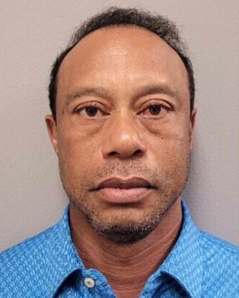 Tiger Woods posing for a mugshot.