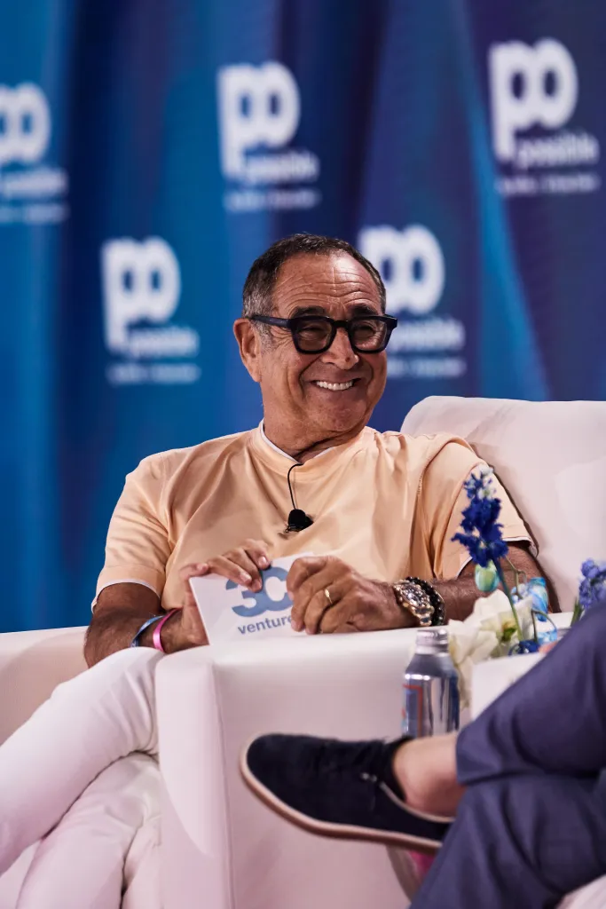 Michael Kassan smiling while speaking at an event, holding a card that reads "30 ventures."