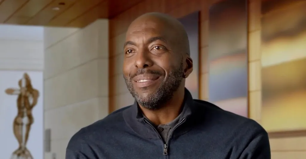 John Salley, former NBA basketball player, smiling.