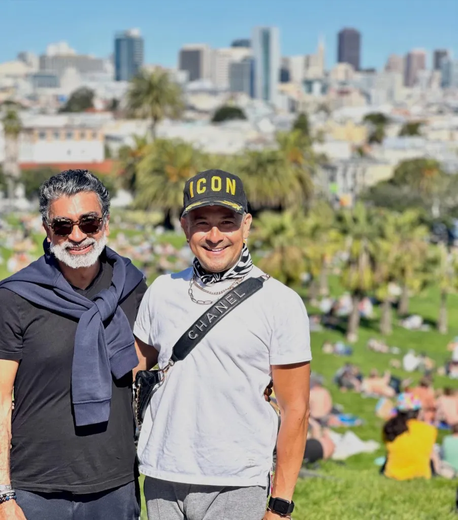 Zafar Padamese Mawani and Guillermo Jafett Hidalgo Ortiz smiling in a park with a city skyline in the background.