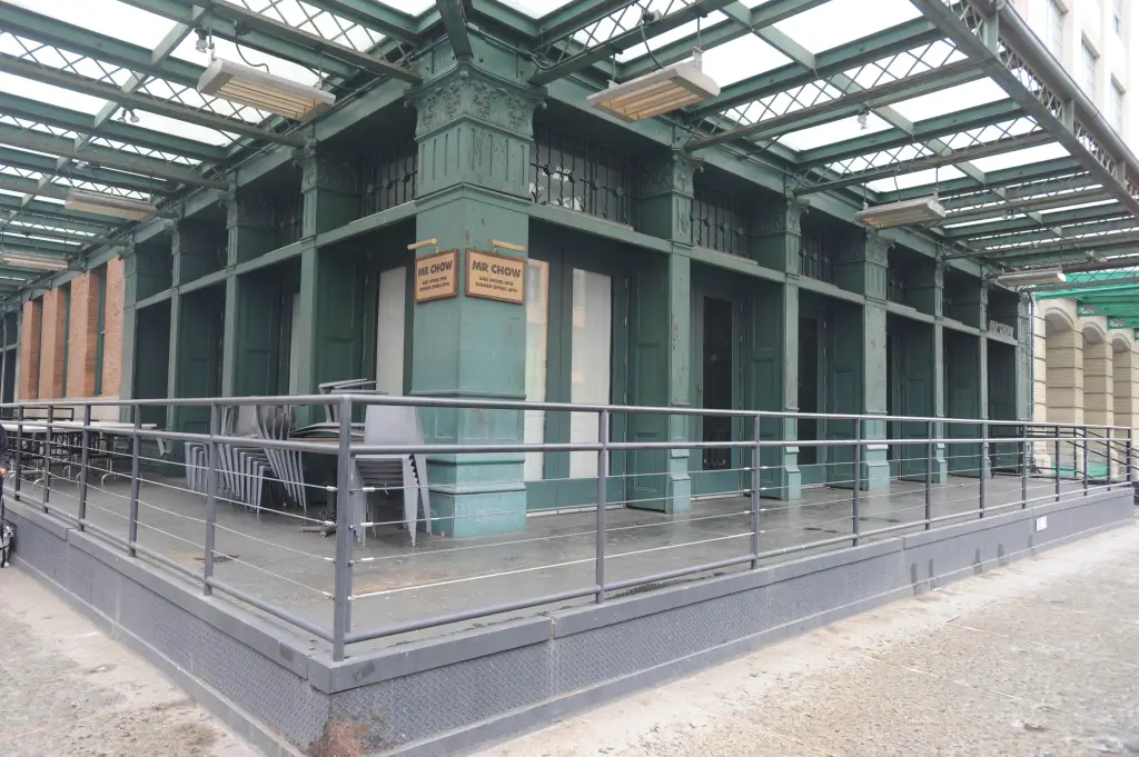 Exterior of Mr. Chow restaurant with bar and dinner opening times visible.