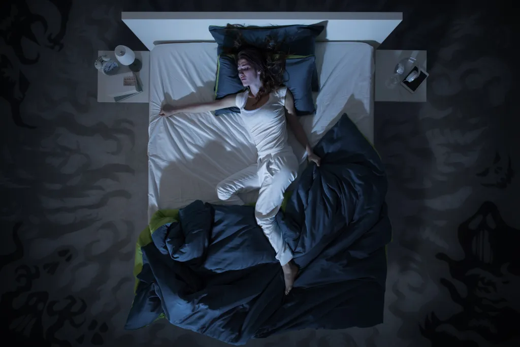 Illustration of a nervous woman suffering from insomnia, lying in bed late at night with nightmares, top view.