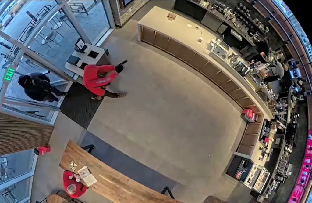 One of the would-be robbers aimed a gun at two employees behind the counter before rushing the cash register, shoving a female worker out of the way.
