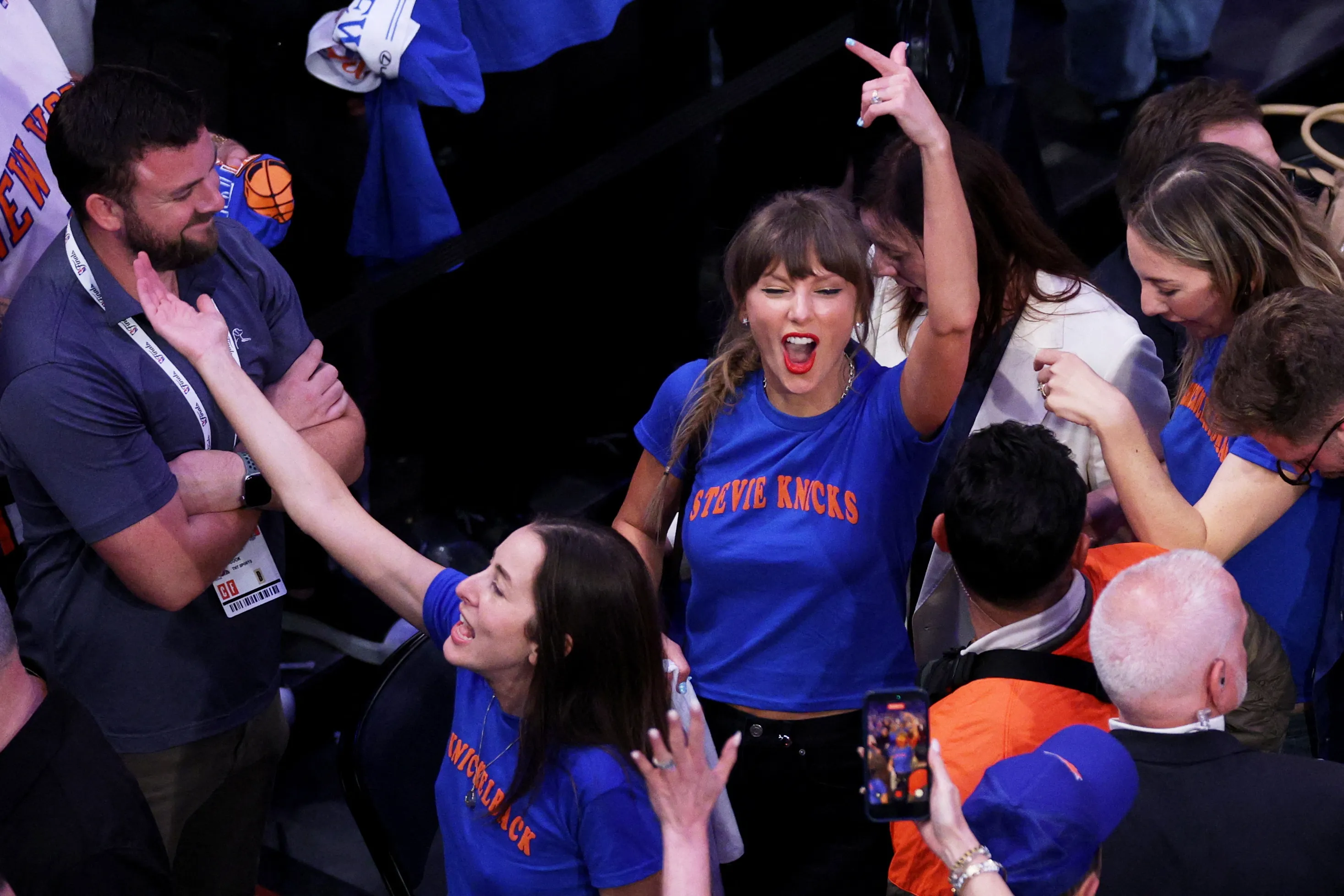 Taylor Swift, Alana Haim, and Este Haim cheer on the New York Knicks during the 2026 NBA Finals.