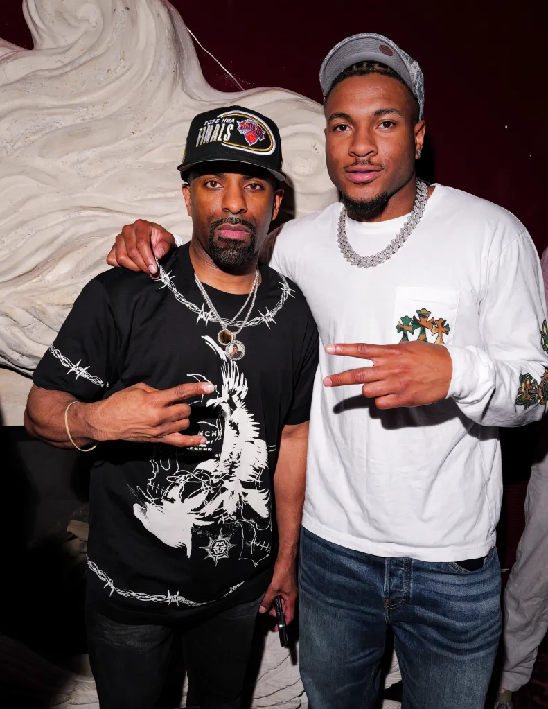 DJ Clue and Miles McBride pose together at the New York Knicks' post-parade celebration.