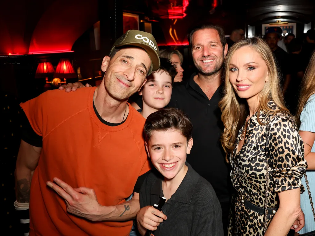 Adrien Brody, Michael Cayre, and Georgina Chapman with children at Chez Margaux.