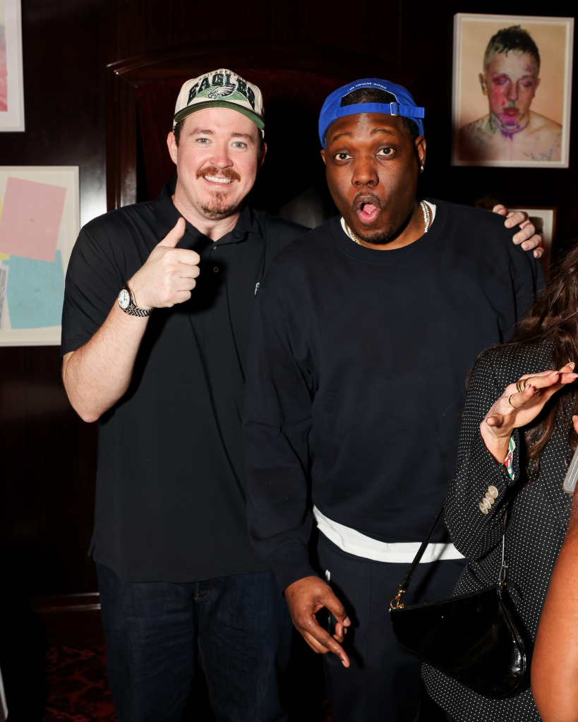 Shane Gillis and Michael Che smiling for a photo.