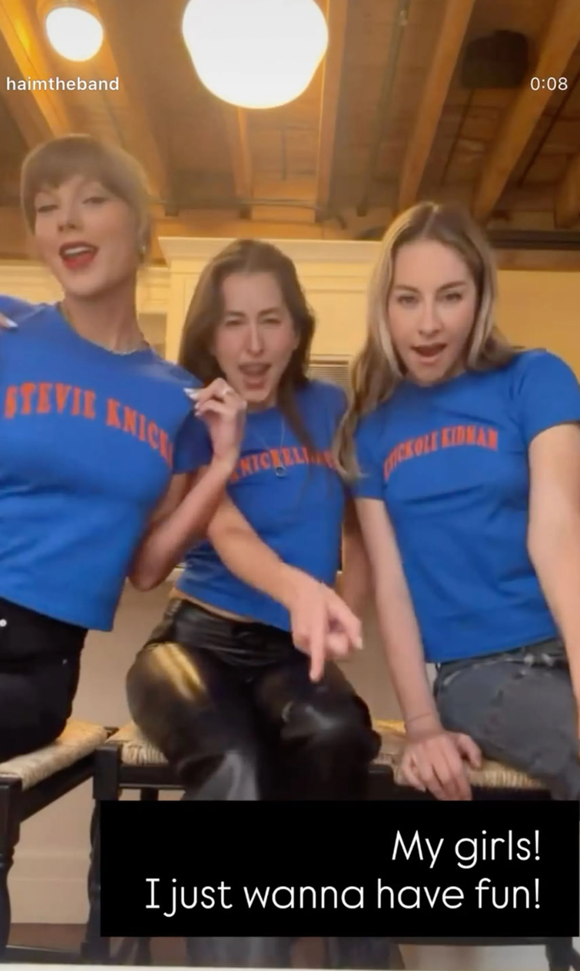 Three women in blue t-shirts with orange lettering, one with "Stevie Nicks," another with "Nickelli," and a third with "Nicole Kidman."