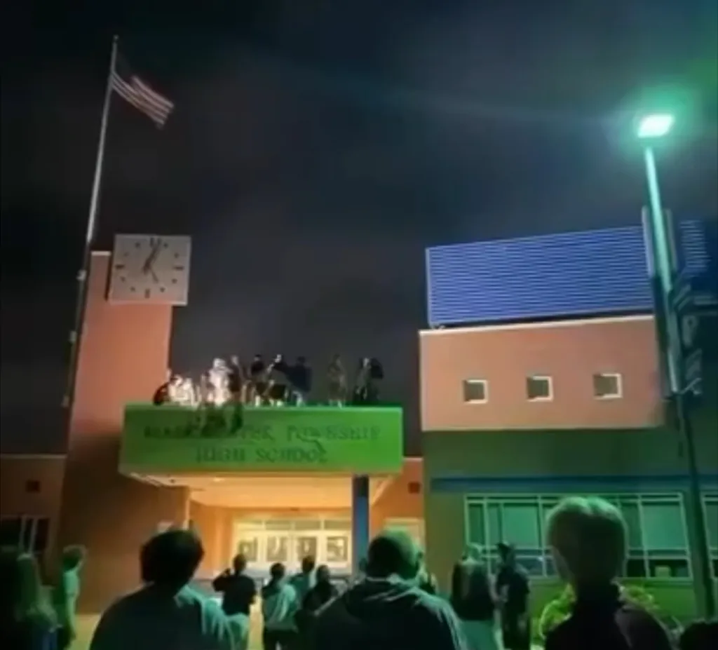 Students stand on top of the entrance to Manchester Township High School during a "senior prank" on June 17, 2026.