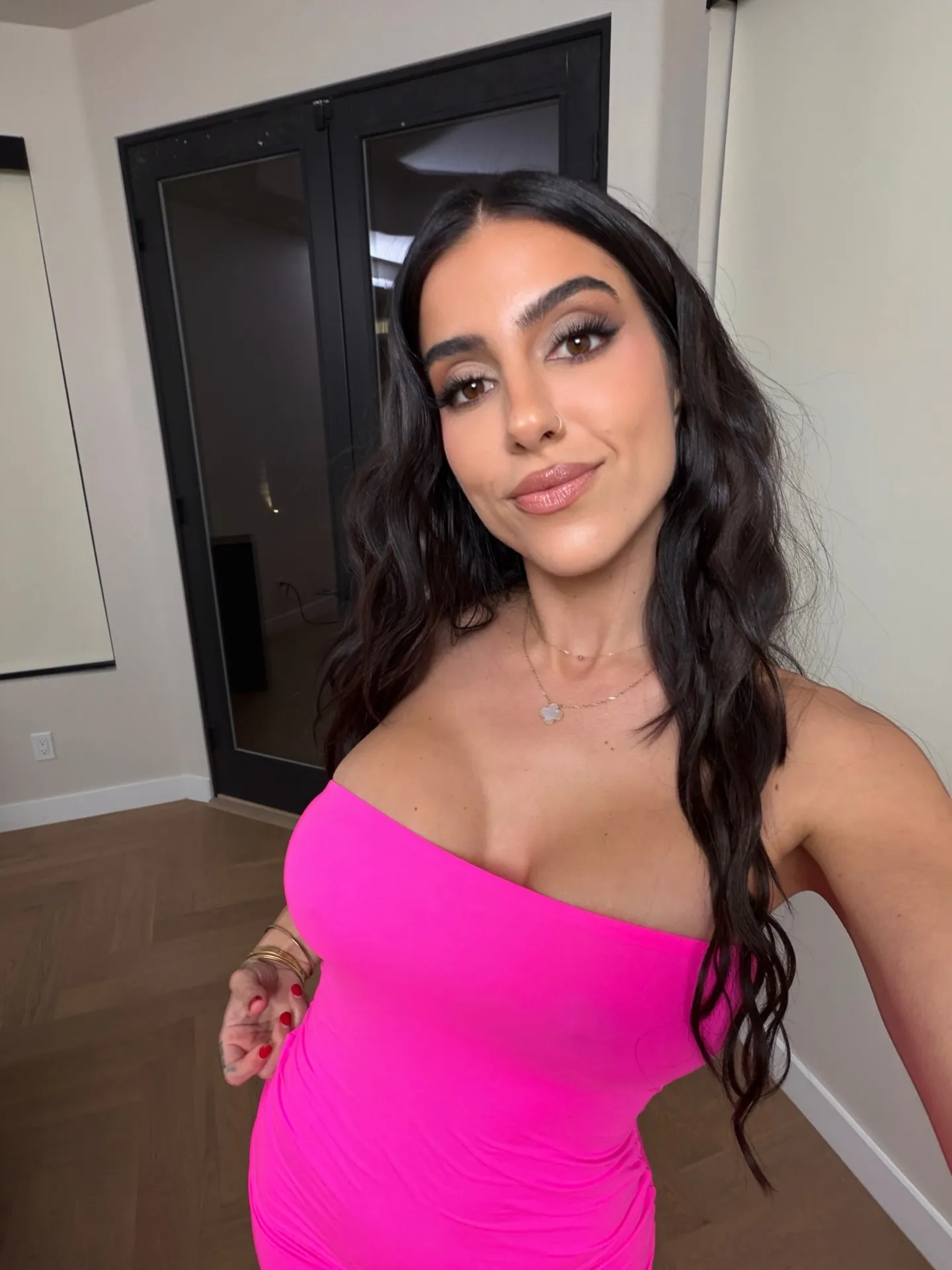 Lena the Plug wearing a bright pink dress.