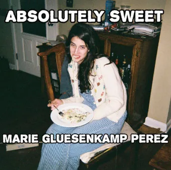 Marie Gluesenkamp Perez with pasta hanging from her mouth, with text "ABSOLUTELY SWEET MARIE GLUESENKAMP PEREZ".