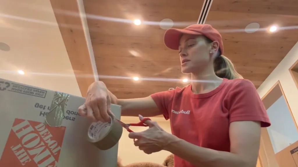 Peta Murgatroyd packing a Home Depot box.