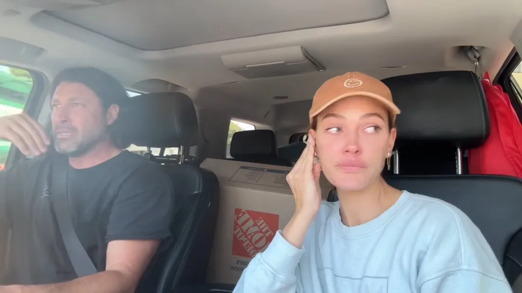 Peta Murgatroyd and Maksim Chmerkovskiy in a car with moving boxes.