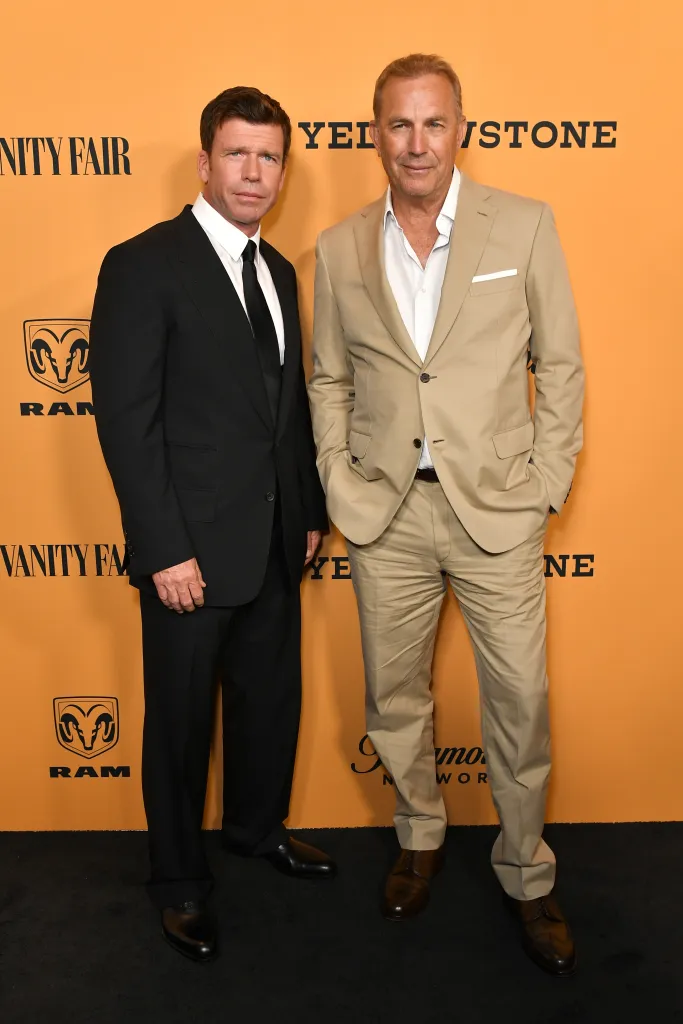 Taylor Sheridan and Kevin Costner posing at the Yellowstone TV show premiere.