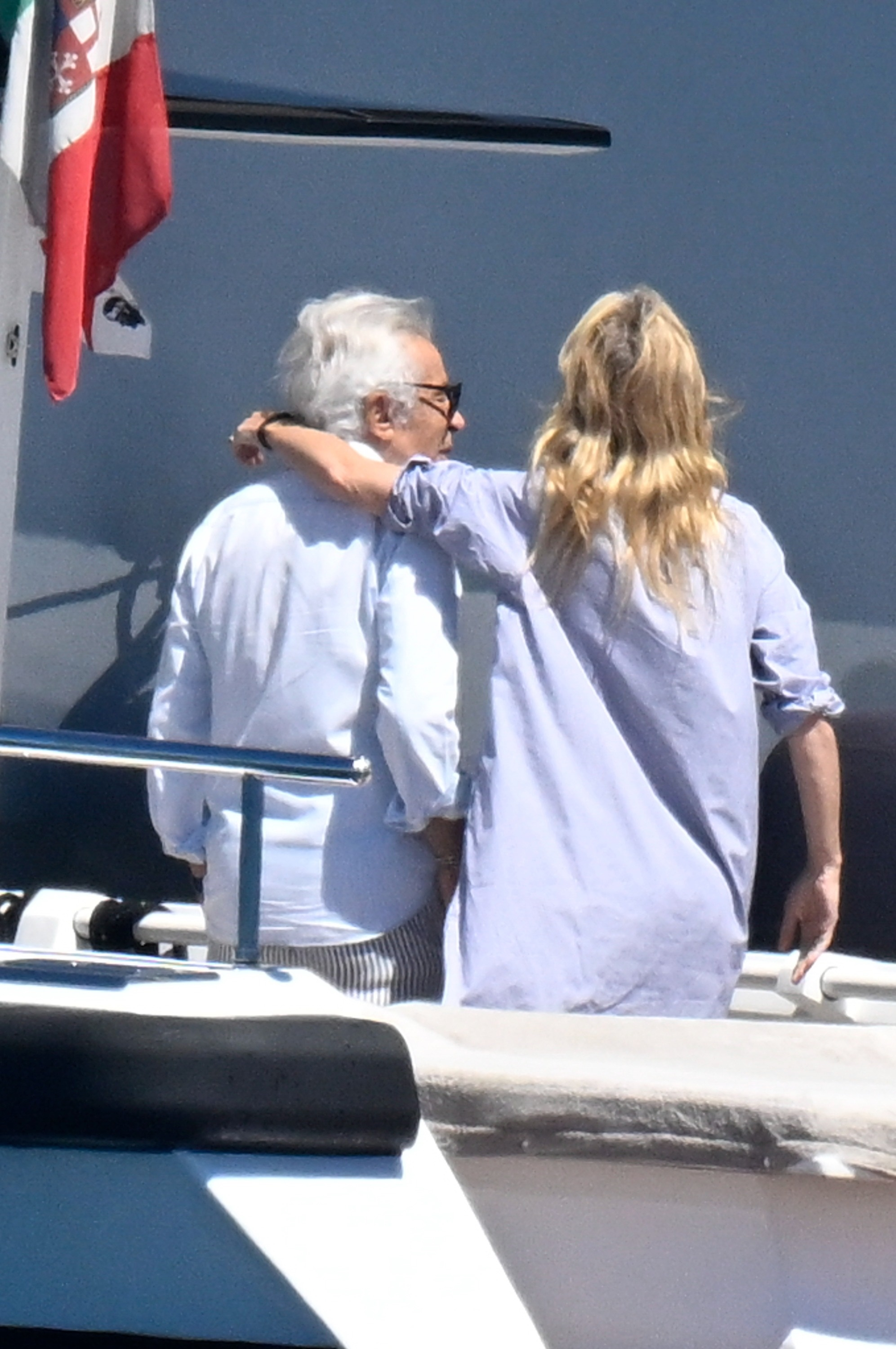 Gwyneth Paltrow with arm around Giancarlo Giammetti on a yacht.