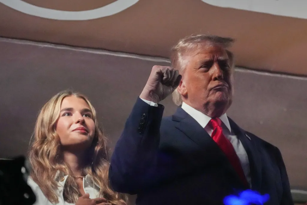 Donald Trump at a basketball game with Kai Trump.