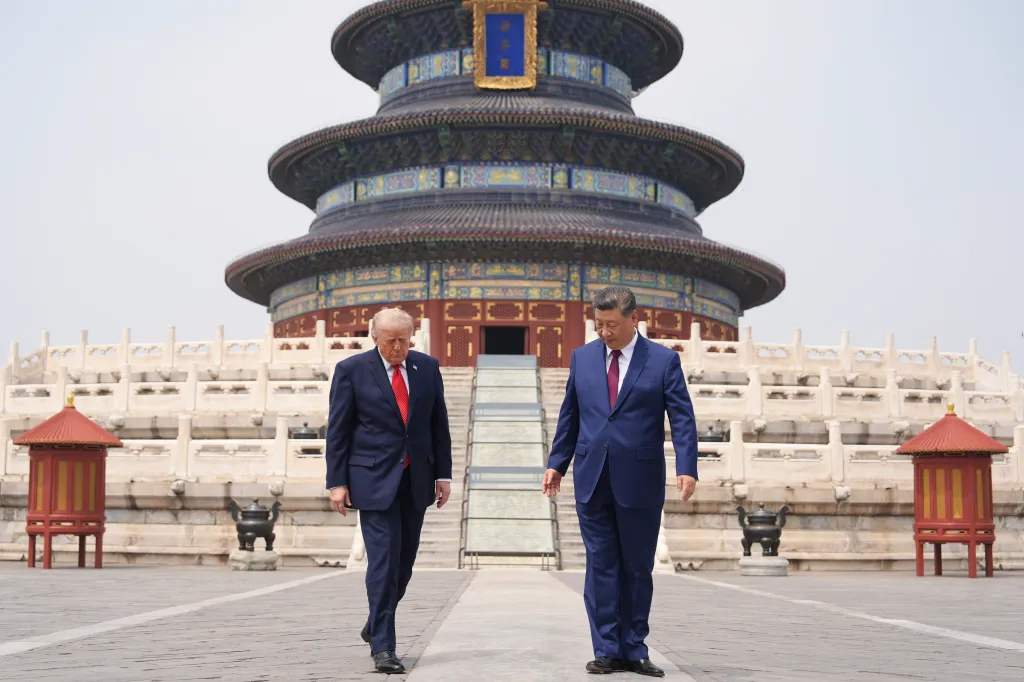 President Donald Trump walks with Chinese President Xi Jinping at the Temple of Heaven.