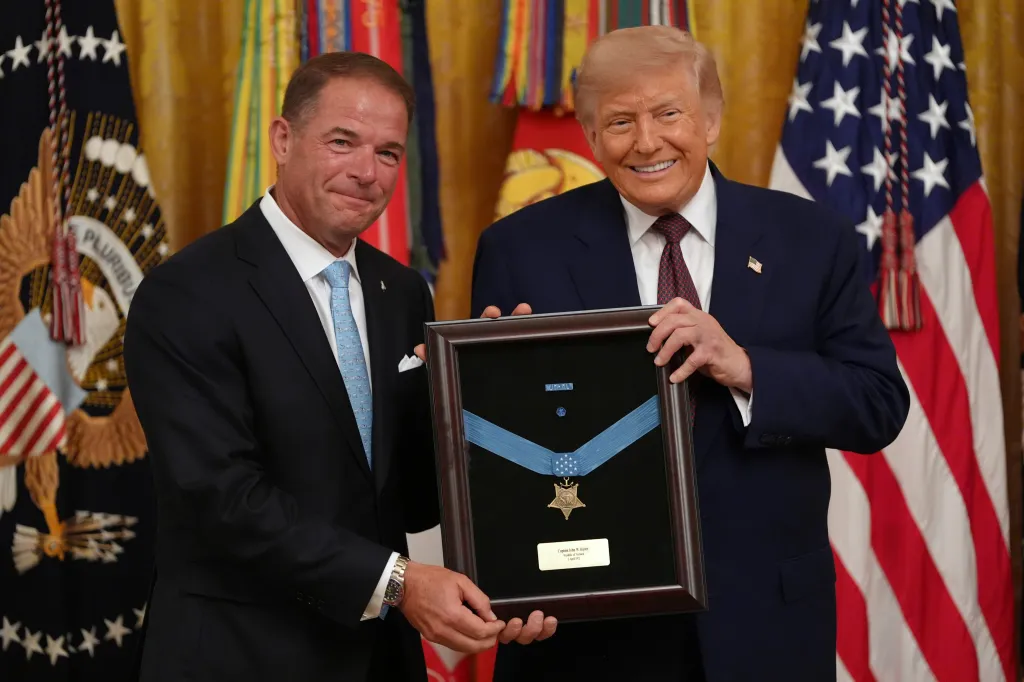 Donald Trump and Tom Ripley holding the Medal of Honor.