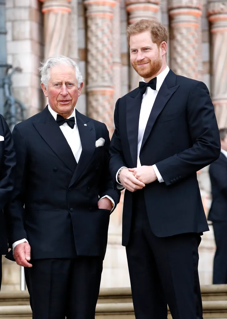 Prince Charles and Prince Harry in black tuxedos.