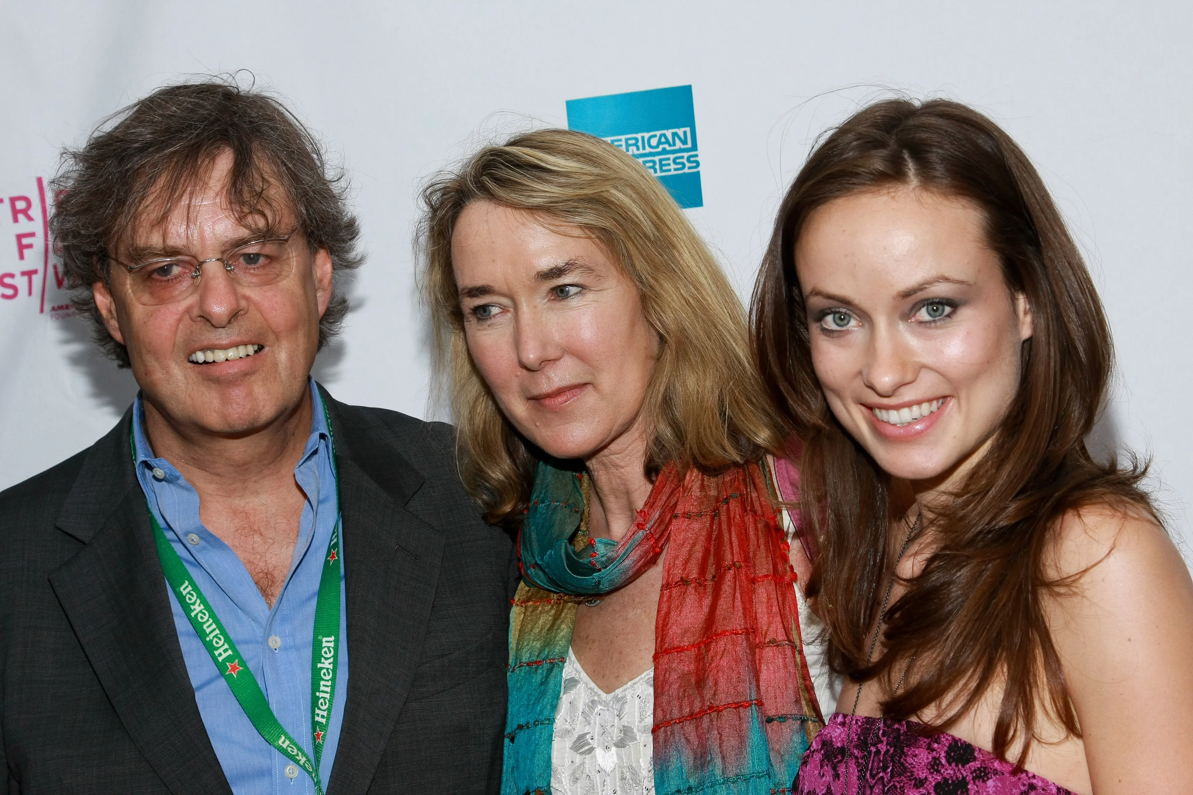 Producer Andrew Cockburn, director Leslie Cockburn, and actress Olivia Wilde smiling at the "American Casino" premiere.