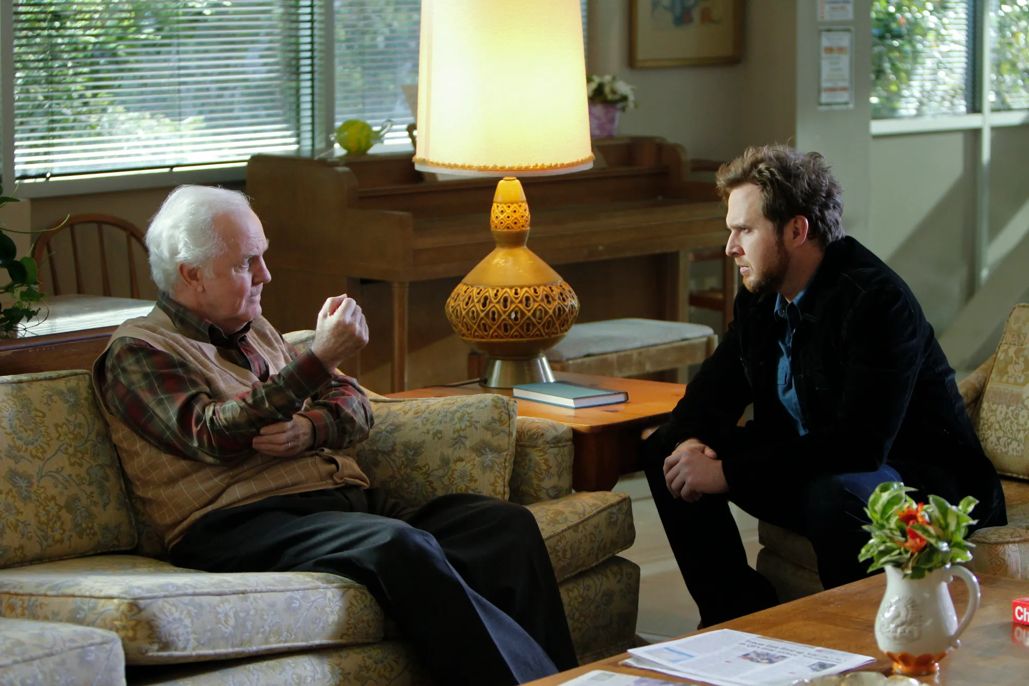 Charles Ross (left) and Adam (right) in a living room scene from CSI: NY.