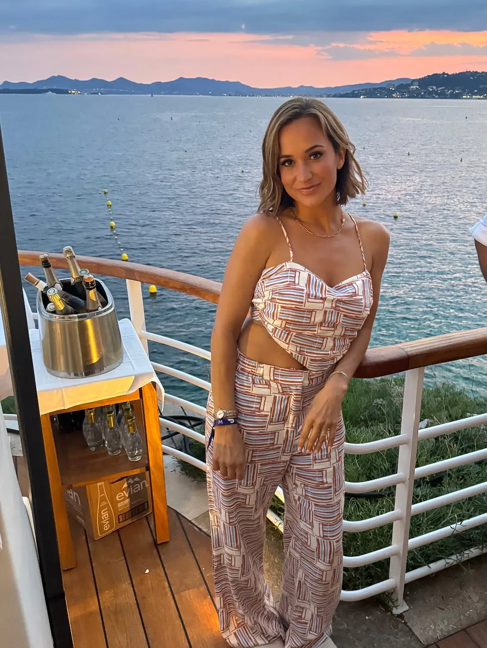 Reporter Dianna Russini on a boat with water and mountains in the background.