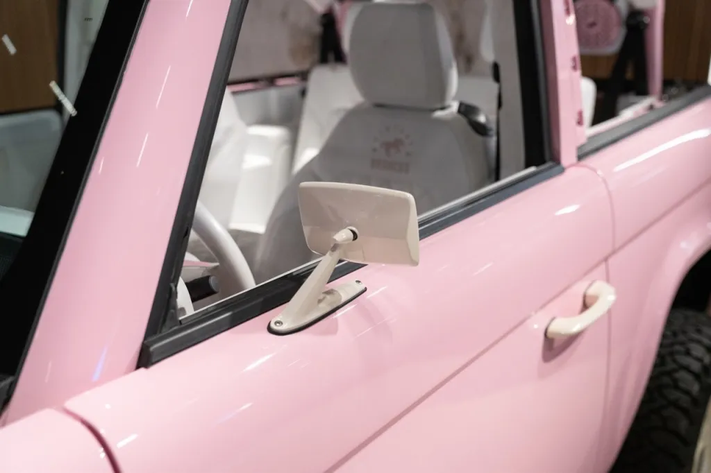 A close-up of a pink Ford Bronco.