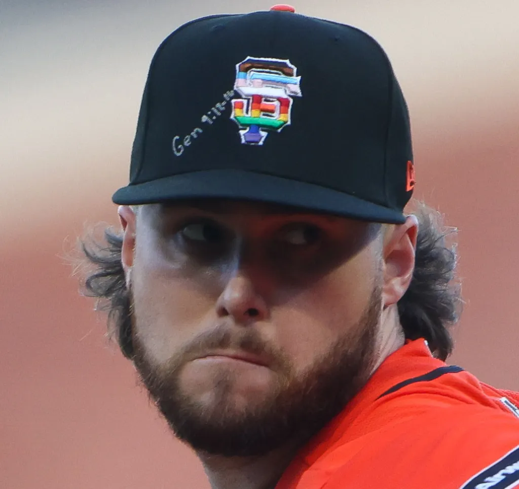 San Francisco Giants pitcher Landen Roupp with a rainbow-colored Giants logo and "Gen 1:1-12" written on his baseball cap.