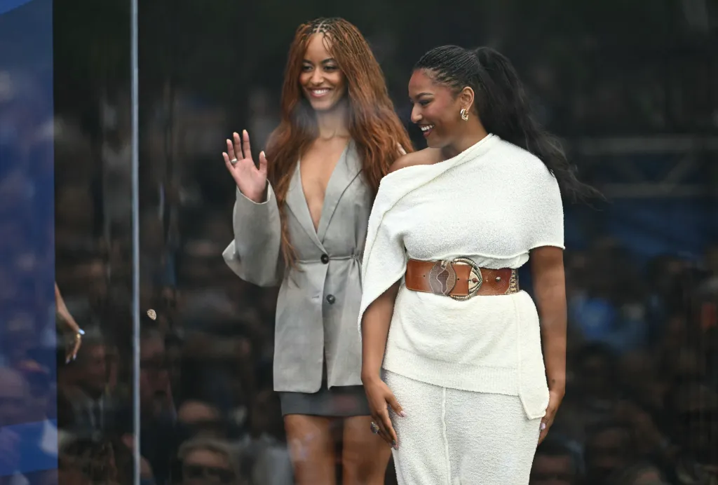 Malia and Sasha Obama smiling at the opening of the Barack Obama Presidential Center.