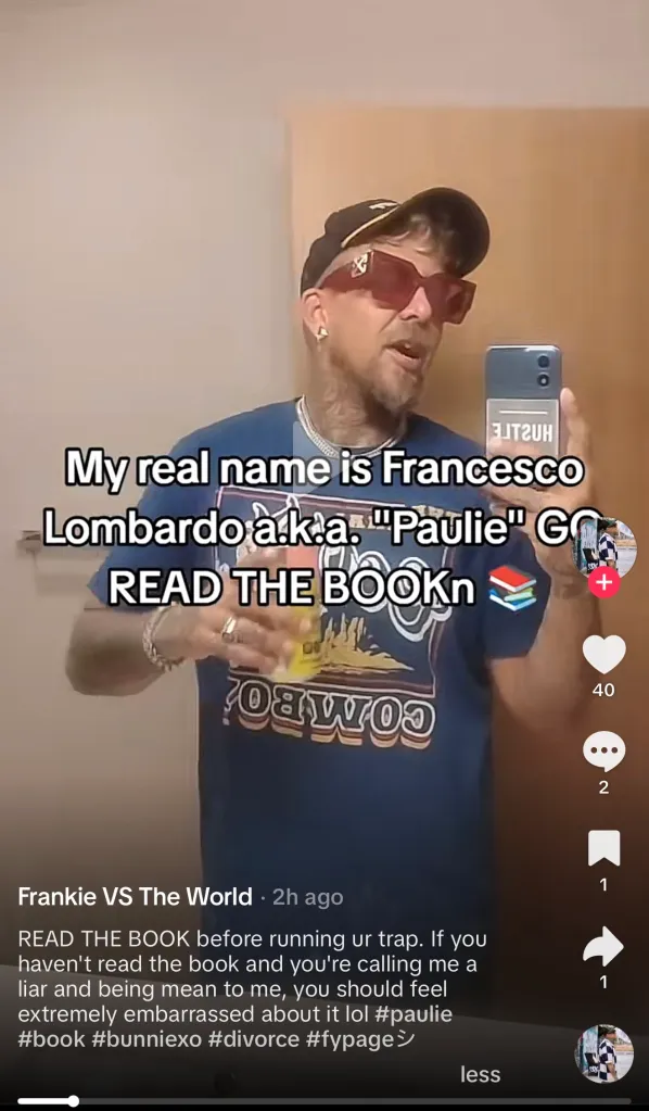 A man with a beard, sunglasses, and a cap filming himself in a mirror, with text overlay "My real name is Francesco Lombardo a.k.a. "Paulie" GO READ THE BOOK".