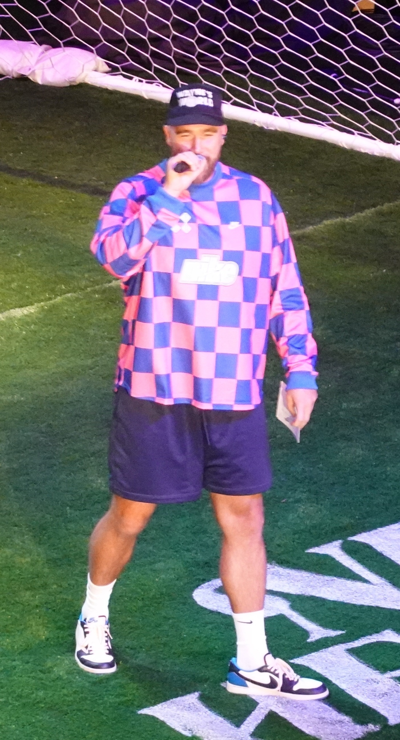 Jason Kelce wearing a pink and blue checkered jersey and a