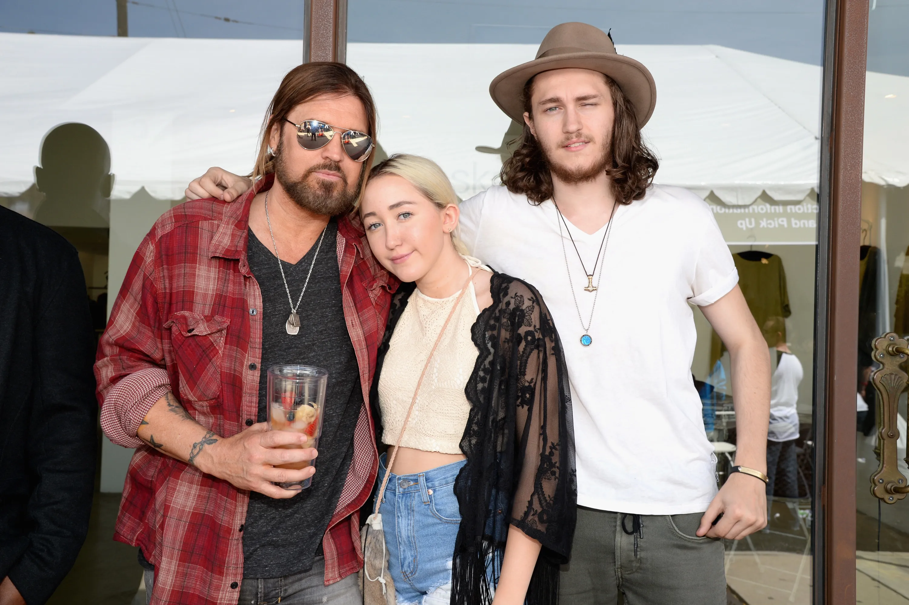 Billy Ray Cyrus, Noah Cyrus, and Braison Cyrus pose together.