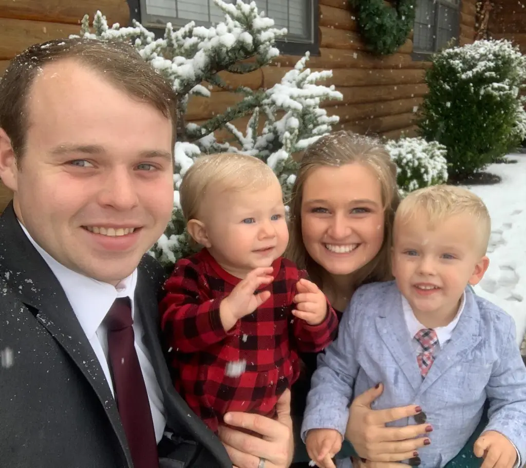 Joseph and Kendra Duggar pose in the snow with their two children.