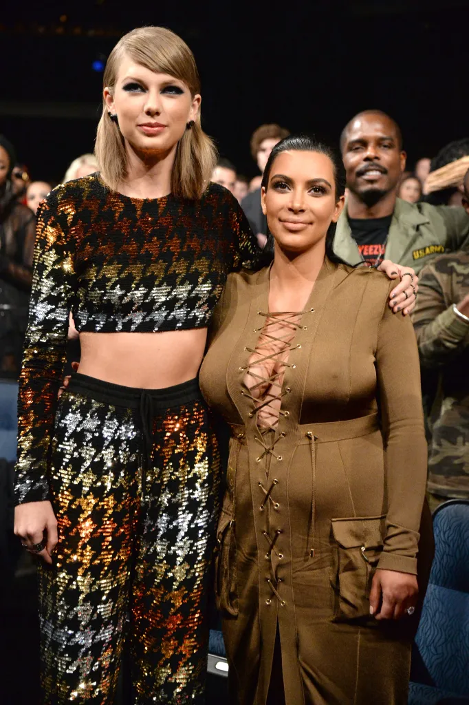 Taylor Swift and Kim Kardashian West pose together at the 2015 MTV Video Music Awards.