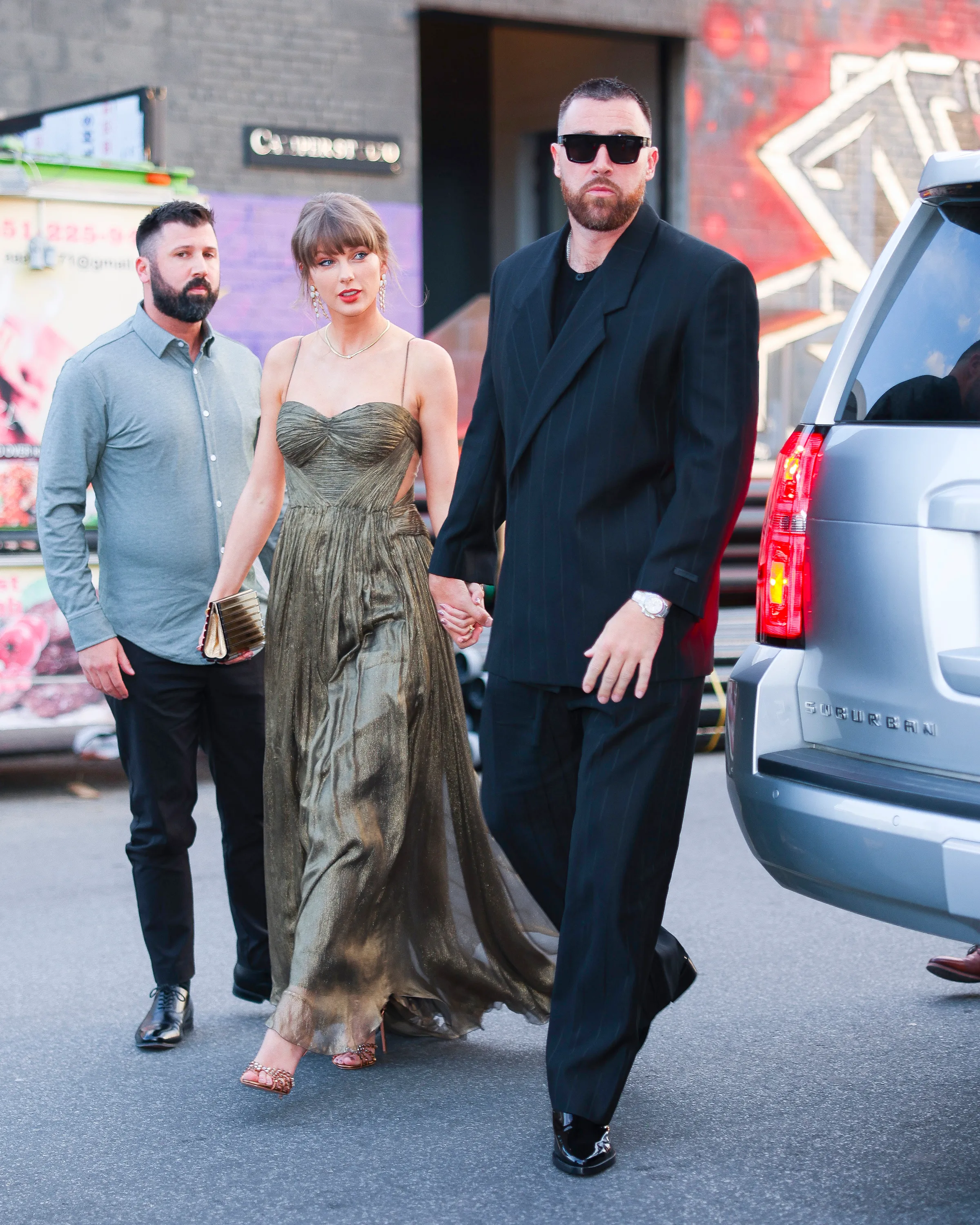 Taylor Swift and Travis Kelce walking hand-in-hand in New York City.