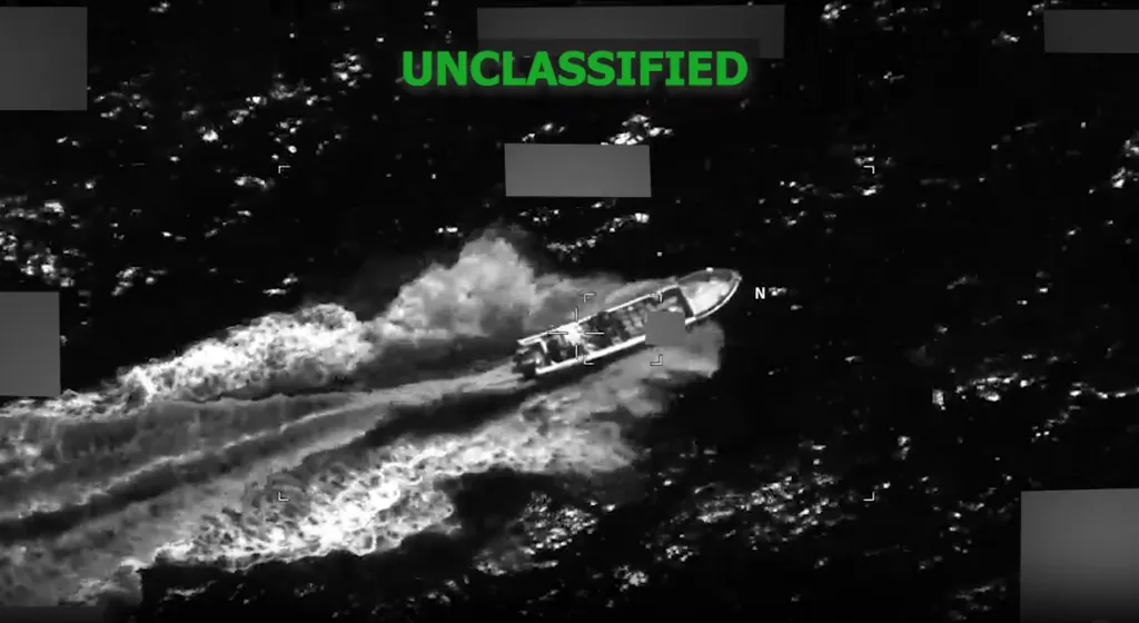 Thermal image from an aerial perspective showing a drug boat on the water, with "UNCLASSIFIED" in bright green at the top.