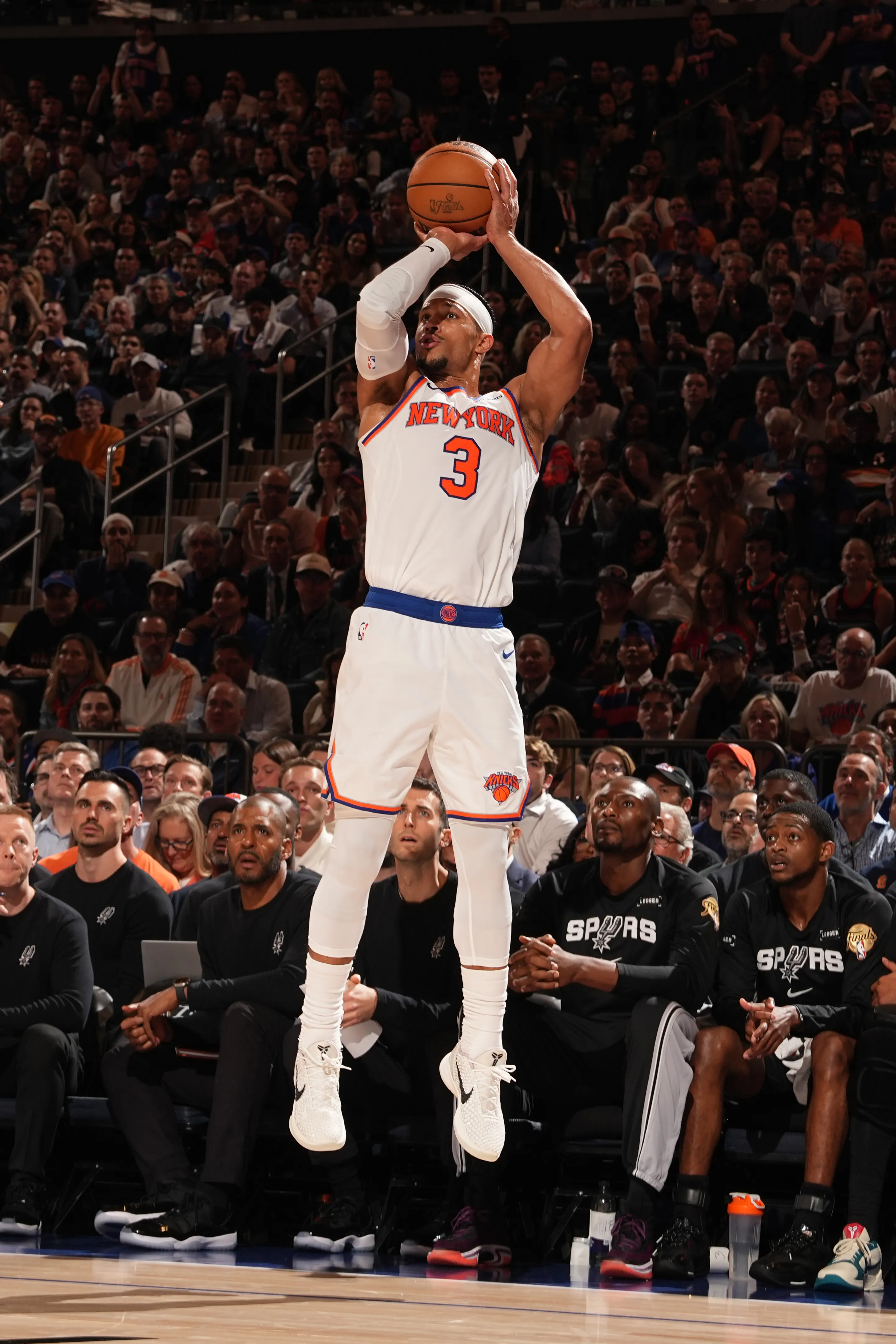 New York Knicks player Josh Hart #3 shoots a three-point basket during a game against the San Antonio Spurs.
