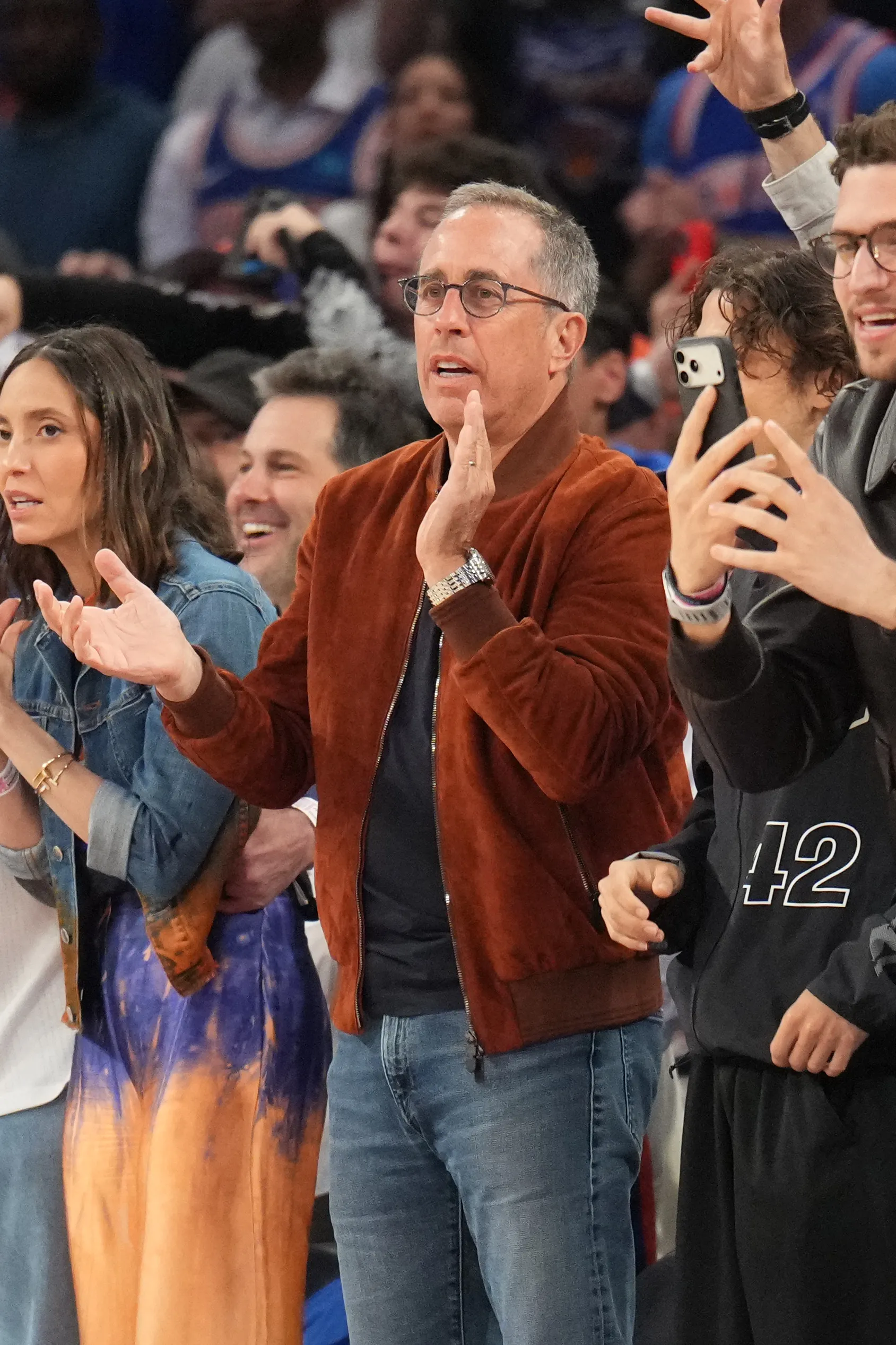 Jerry Seinfeld watching a basketball game.