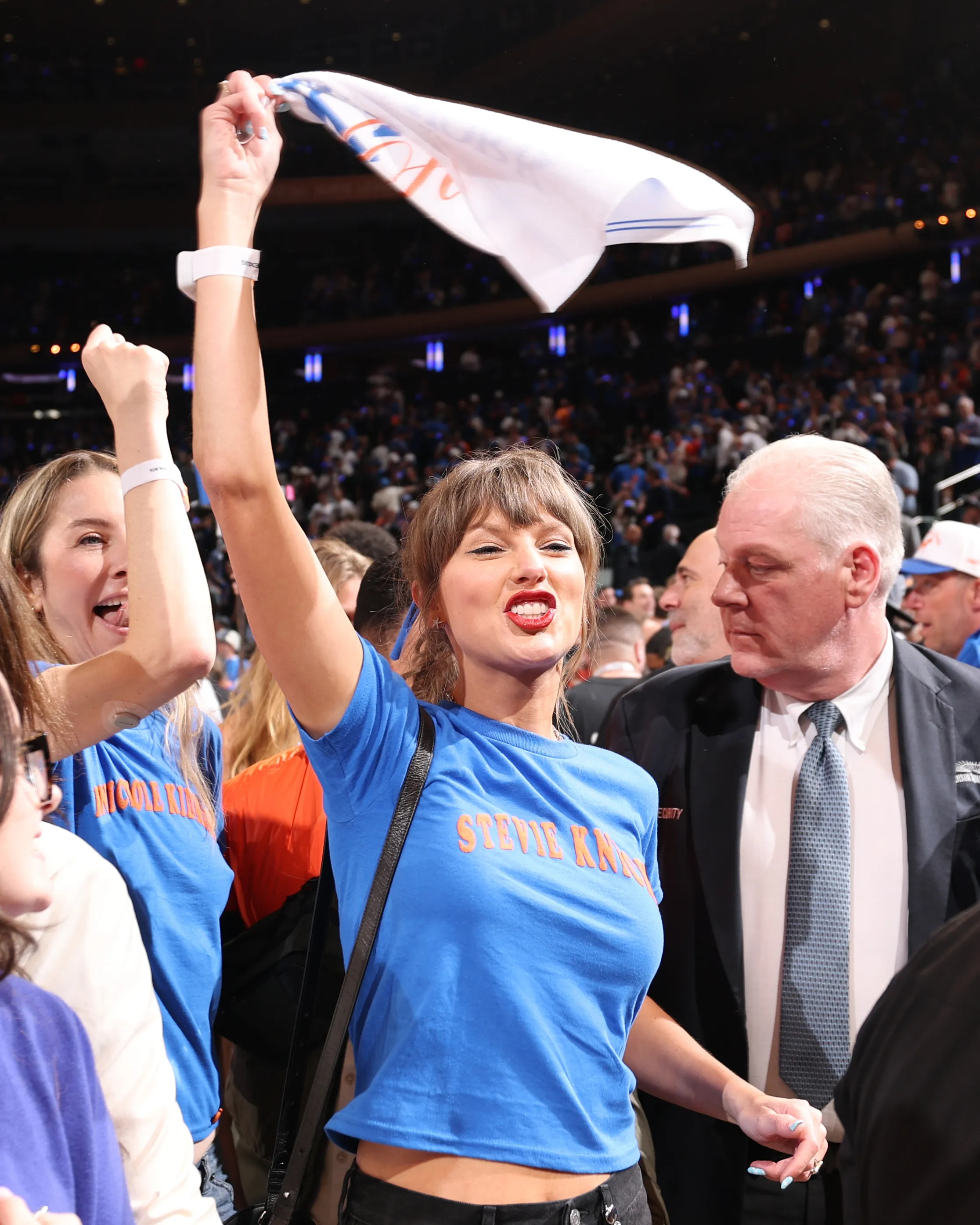 Taylor Swift celebrating at an NBA game.