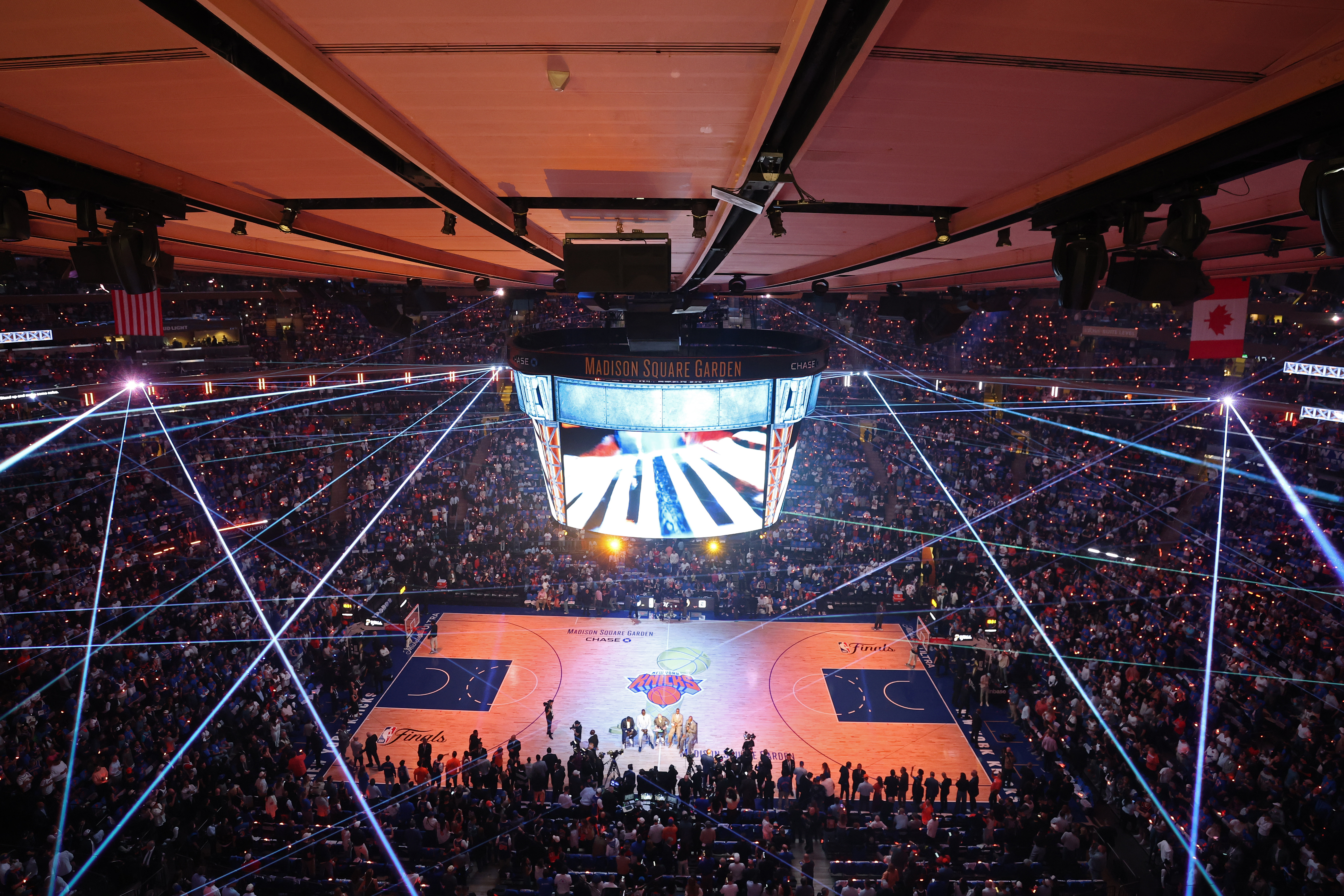 An overhead view of Madison Square Garden during Game Four of the 2026 NBA Finals, with the court lit up and a large jumbotron hanging above center court.