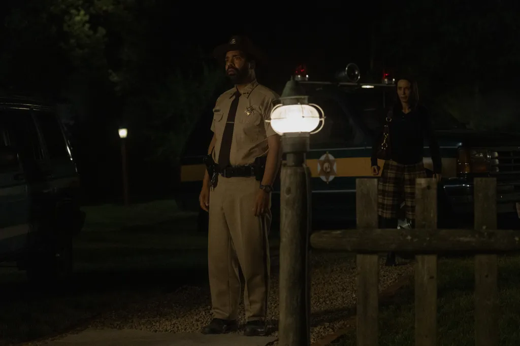 Sheriff Carroll and a woman stand outside at night.