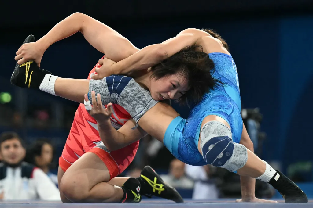Japan's Tsugumi Sakurai (red) wrestles Moldova's Anastasia Nichita (blue) at the Paris 2024 Olympic Games.