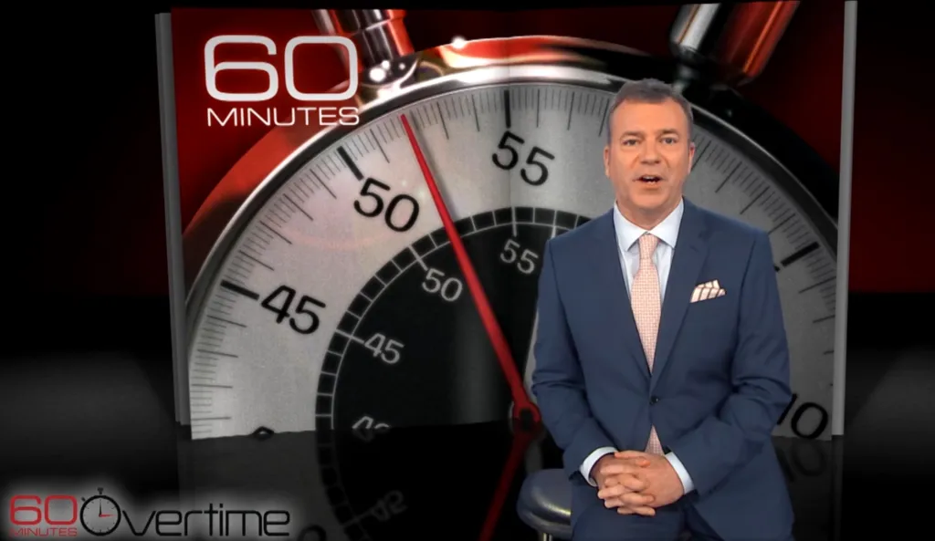 Jon Wertheim talking about 60 Minutes Overtime, with a stopwatch and "60 Minutes" logo in the background.