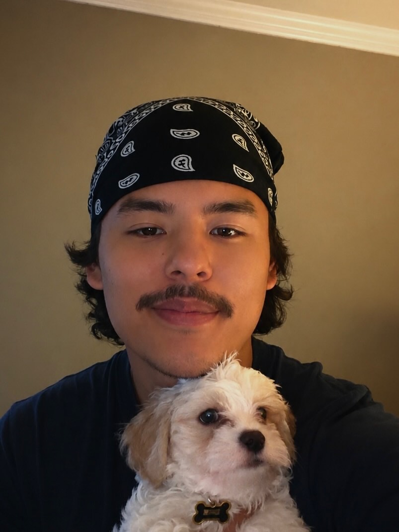 Collin Gosselin holding a small white puppy.