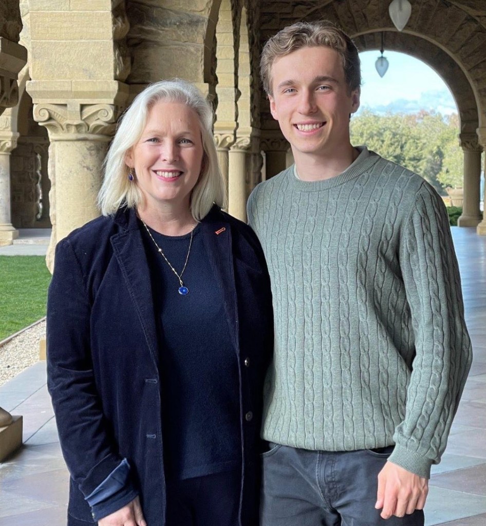 Kirsten and Theo Gillibrand standing outdoors in a stone archway.