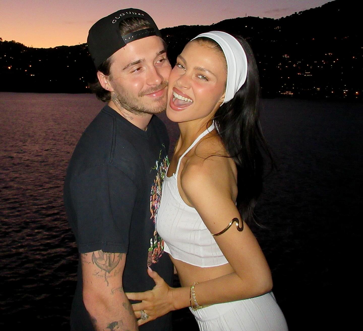 Nicola Peltz and Brooklyn Beckham embracing.