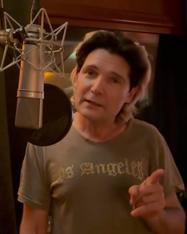 Corey Feldman speaking into a microphone.